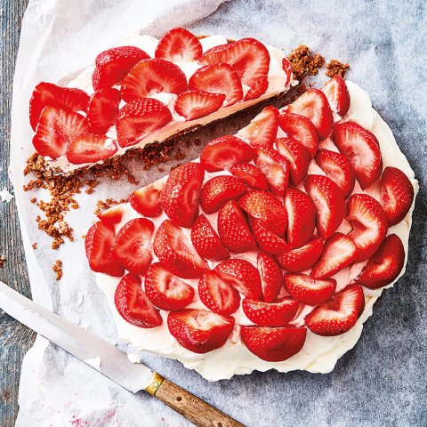 A recipe for No-Bake Strawberry Cheesecake Dessert shot overhead with a thick slice cut out
