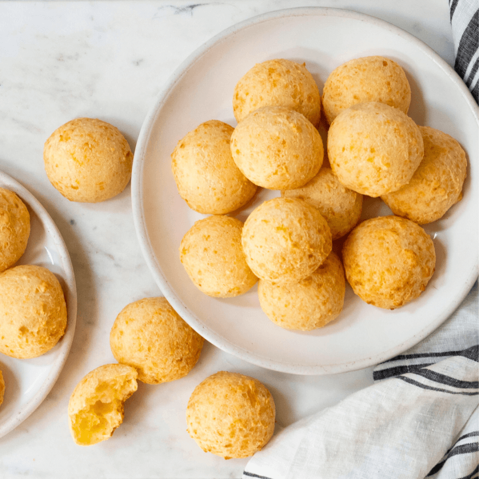 Small round cheese buns on white marble board