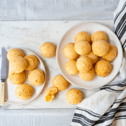 Small round cheese buns on white marble board