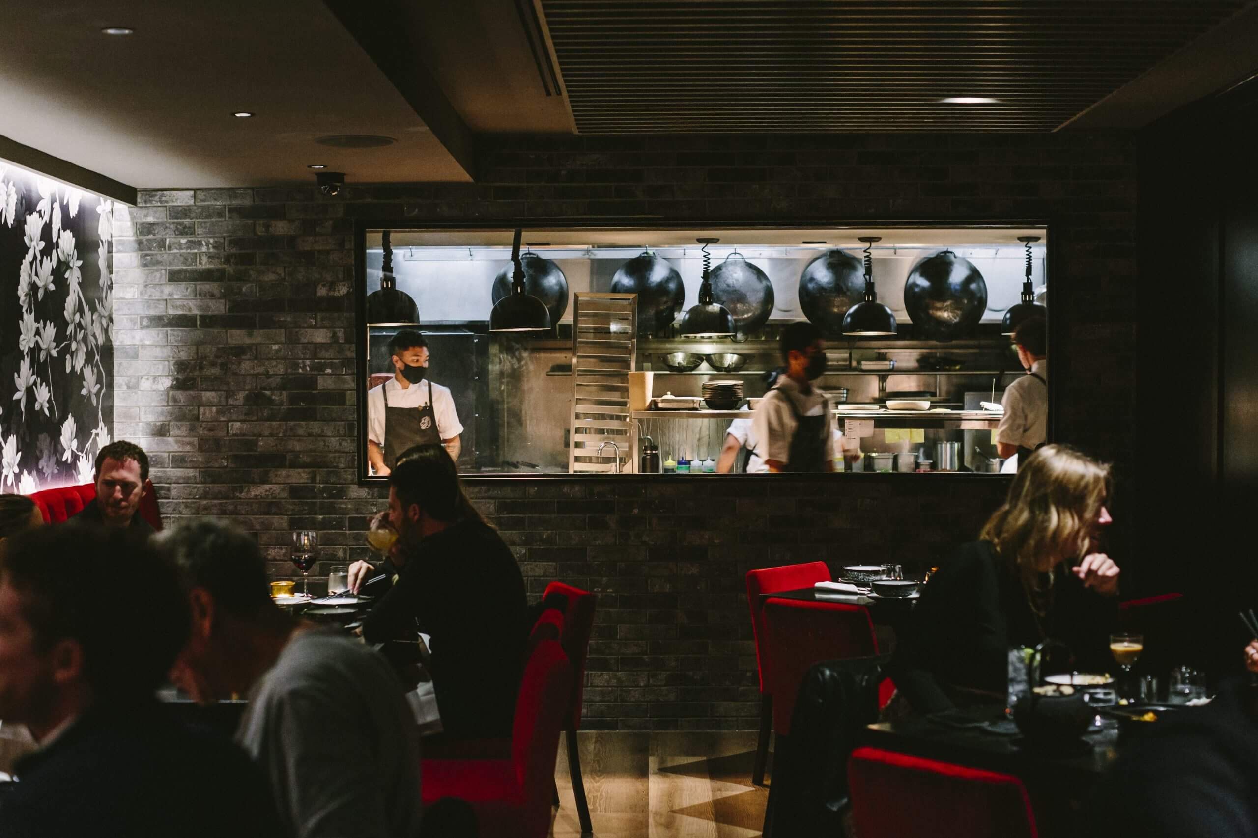 A chef's window overlooks the dining room at MIMI Chinese.