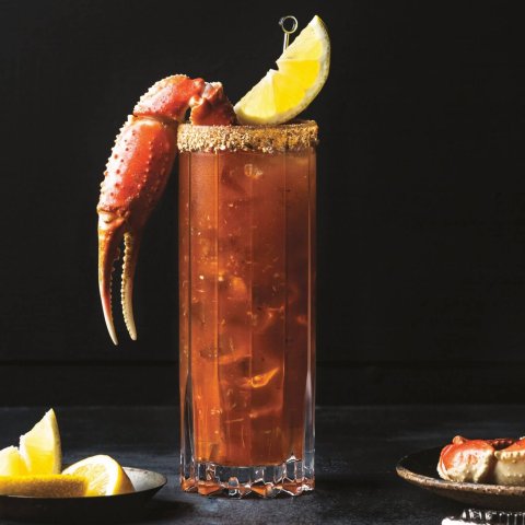 One of the best caesar cocktail recipes with a snow crab claw and lemon wedge.