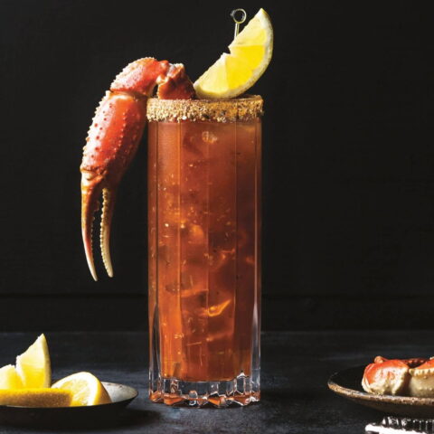 One of the best caesar cocktail recipes with a snow crab claw and lemon wedge.