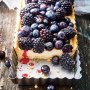 Blueberry, blackberry and white chocolate tart with creamy mascarpone filling in a buttery shortbread crust.