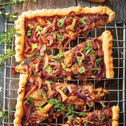 A sliced tart with onions and thyme.