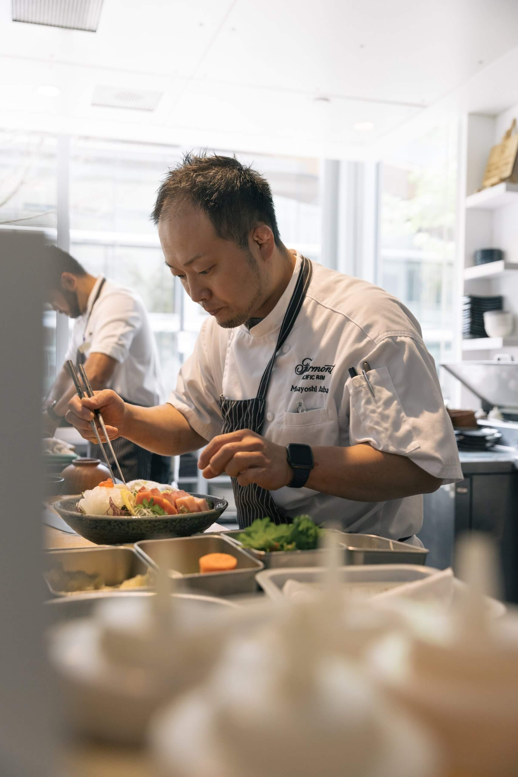 Masayoshi prepares sashimi in a kitchen.
