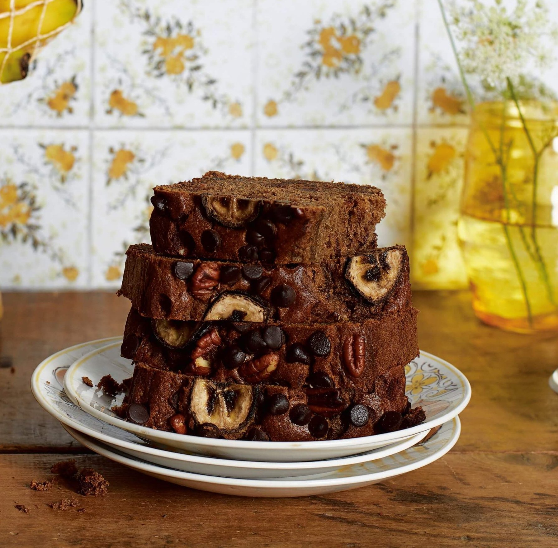Slices of banana bread in front of yellow glasses and linoleum