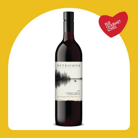 A bottle of red wine in a yellow frame