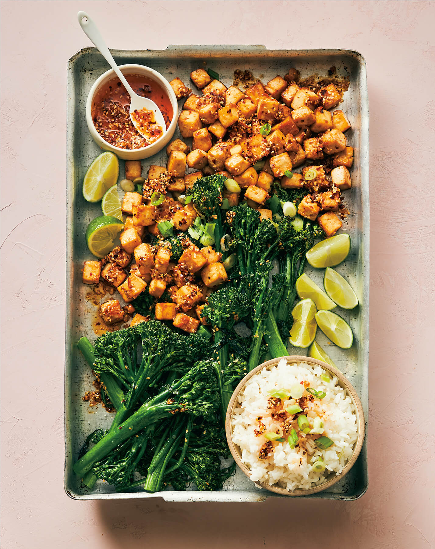 A metal tray with broccoli and sides