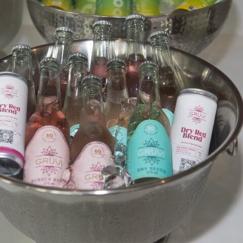 A silver bowl of ice with drinks