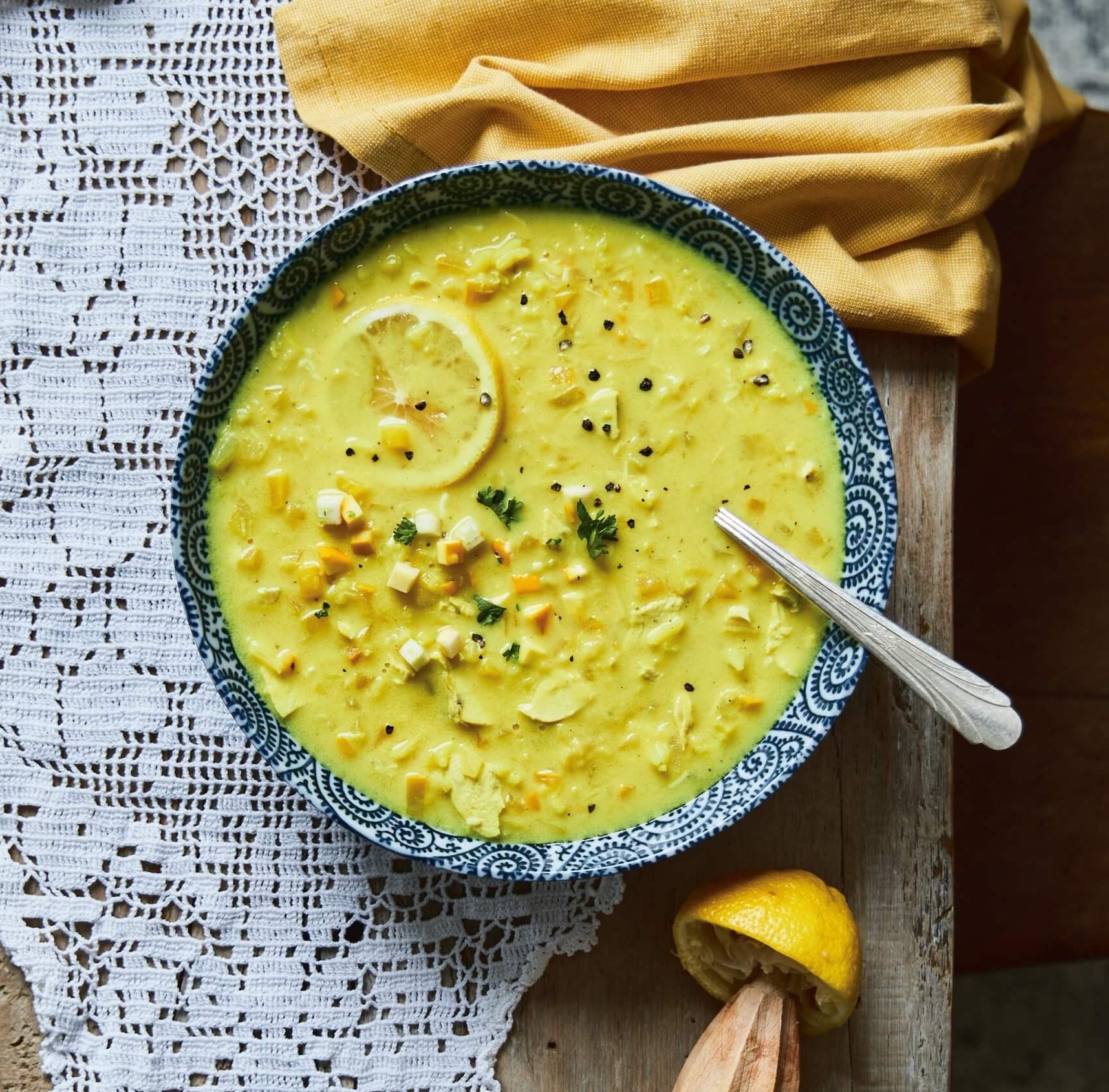 A bowl of chicken and Yellow Zucchini Avgolemono Style Soup recipe from Jennifer Emilson's cookbook