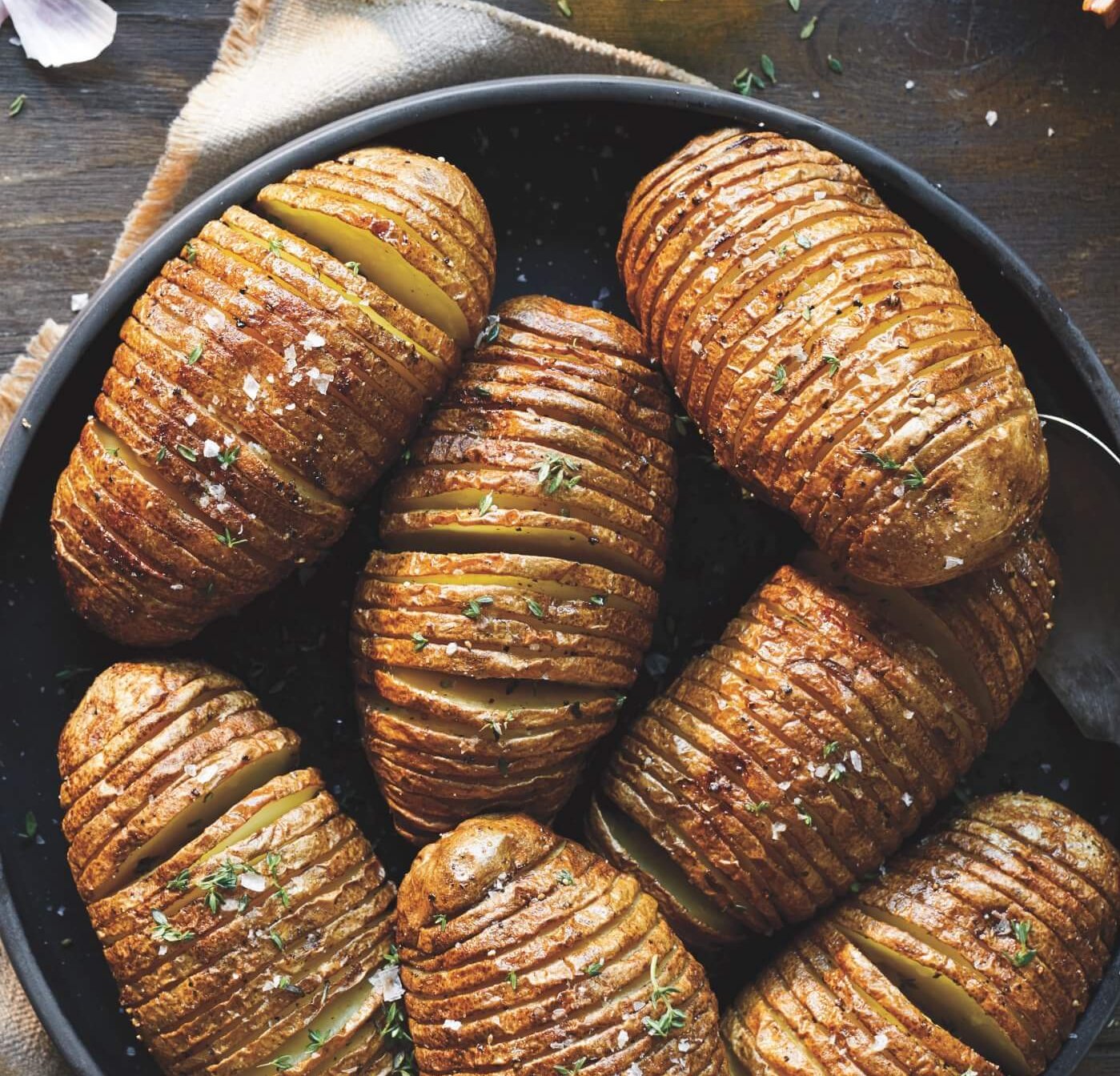 A plate of roasted hasselback potatoes.