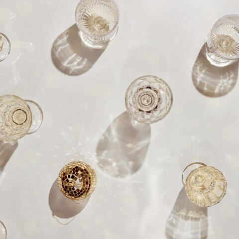 Glasses of champagne and a mini gold disco ball on a table