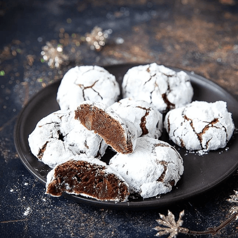 A black plate with cookies on it