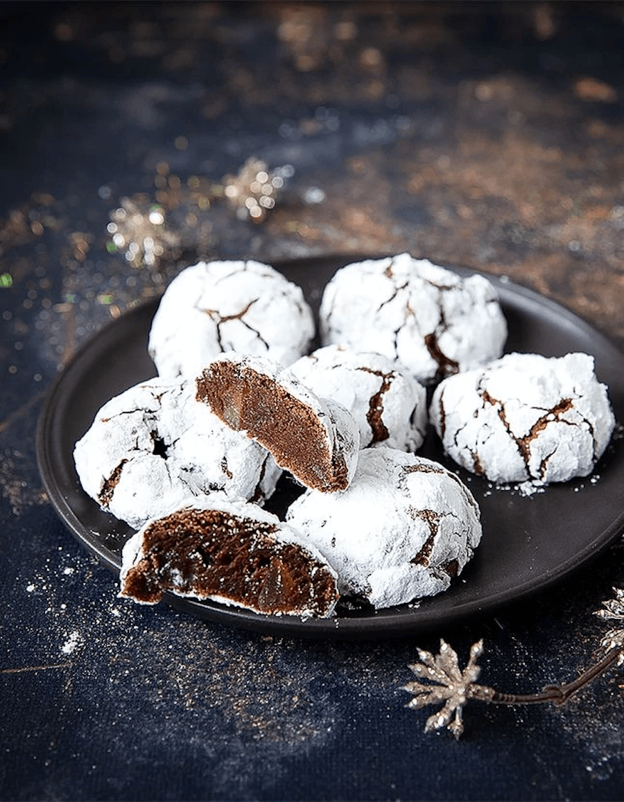 A black plate with cookies on it