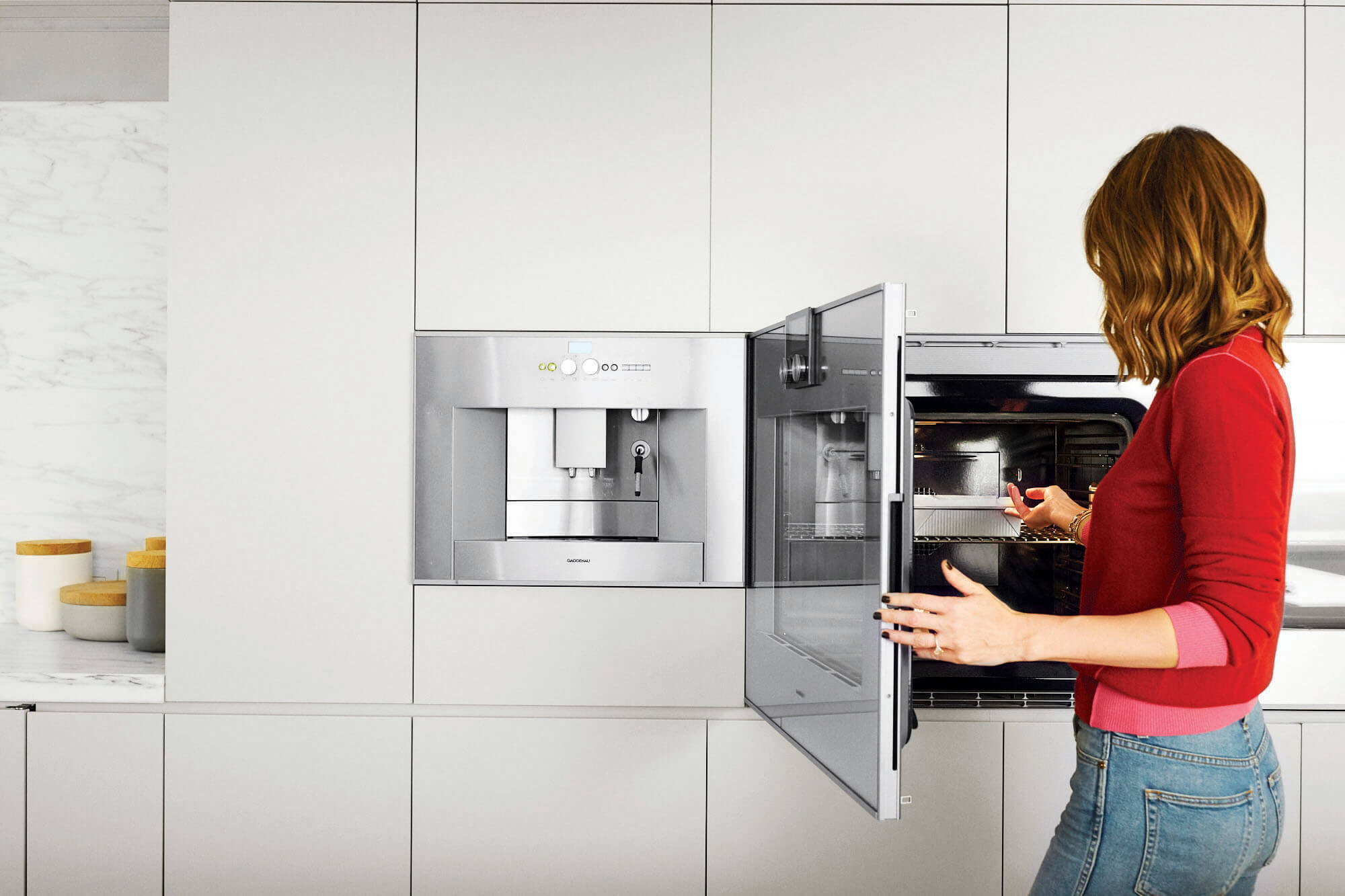 A woman handling a pan of brownies in an oven