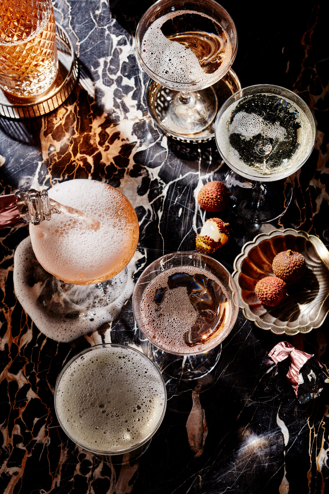 A black marble surface with glasses of the best sparkling wine Canada