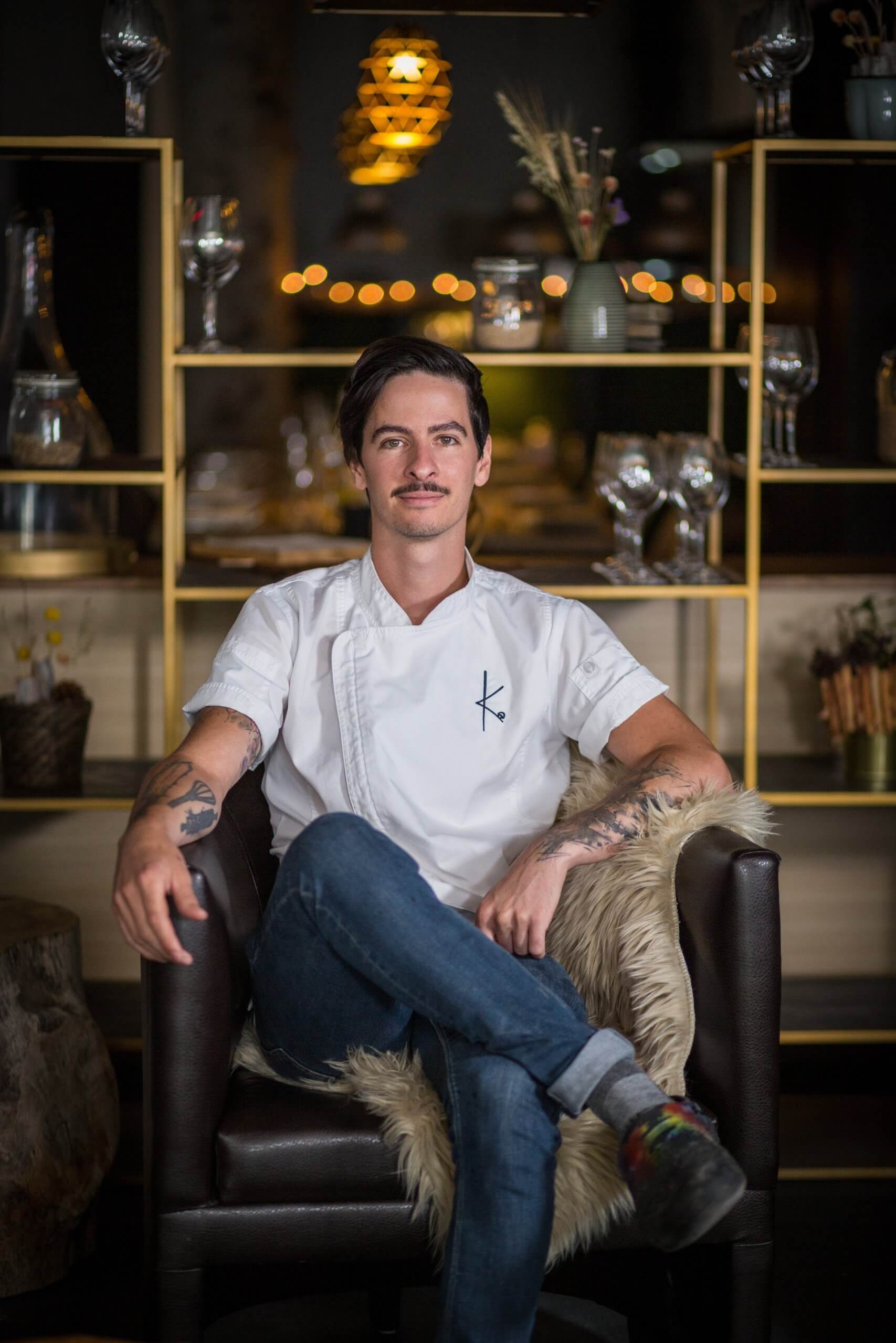 Man in chef uniform sitting on chair