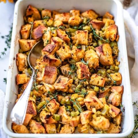 A white baking dish with stuffing in it