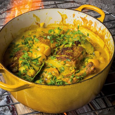 A yellow pot with a Jamaican recipe for curry chicken