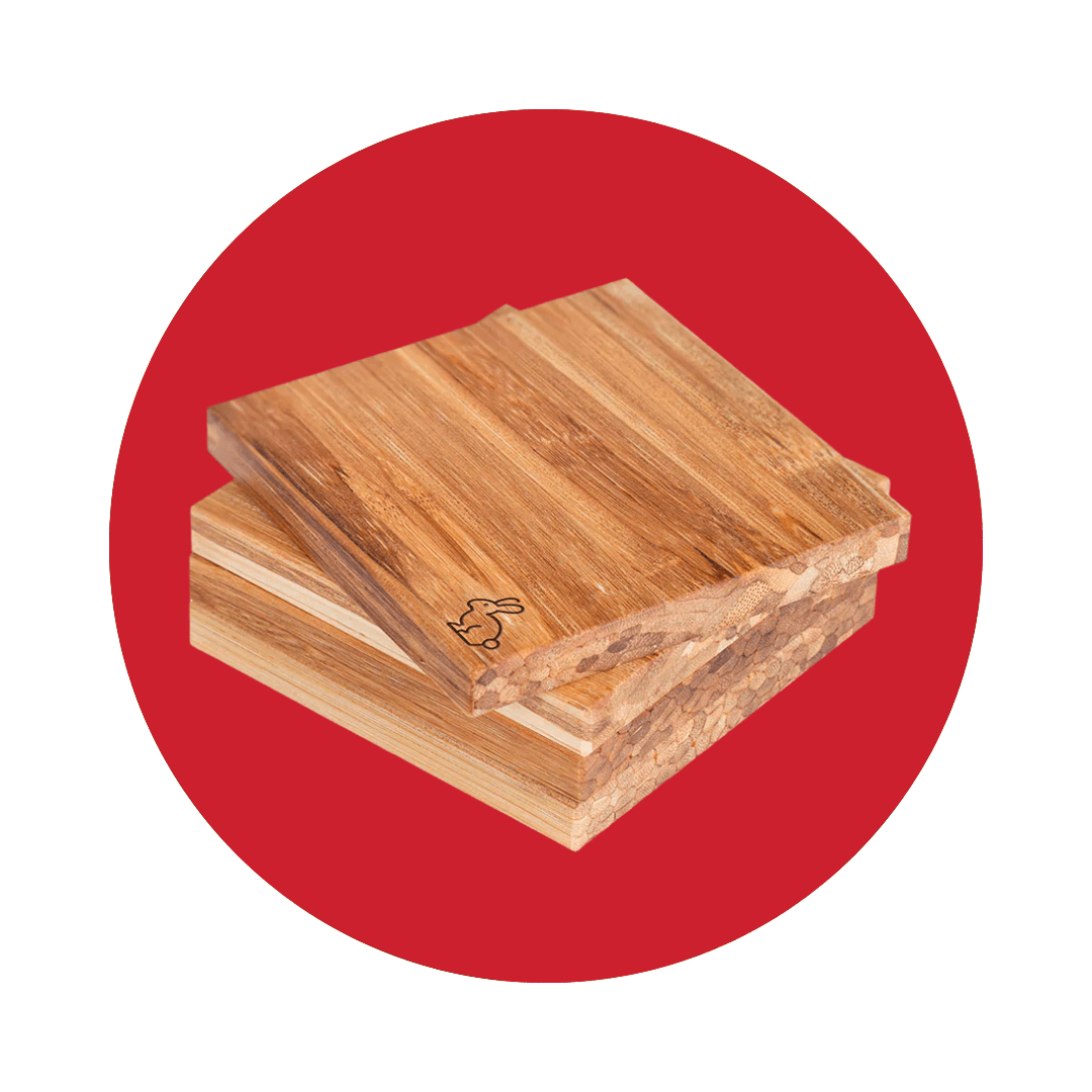 A stack of wooden coasters with a small bunny in the corner on a red circle.