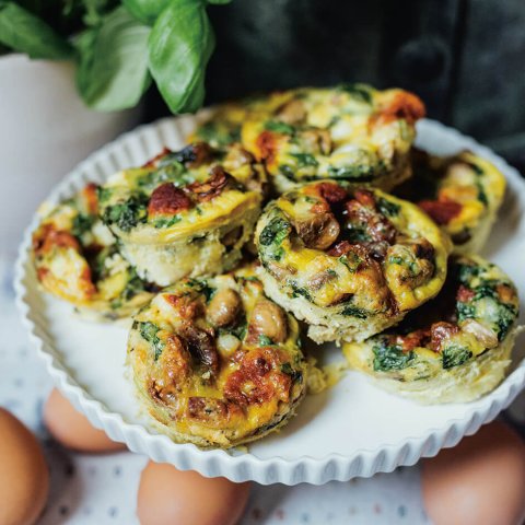 A plate of Mandy's mini egg bites. These protein-rich “brekkie bombs” come from Mandy Wolfe’s More Mandy’s cookbook. Baked in a muffin tin, they combine eggs, sautéed mushrooms and onions, creamy heavy cream, shredded cheddar, sun-dried tomatoes and fresh basil. They're savoury, low-carb, and built for make-ahead breakfasts.