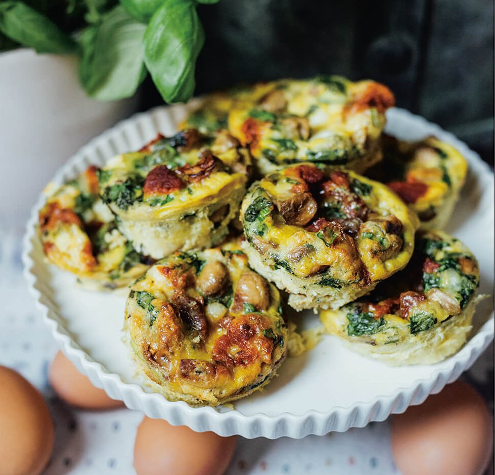 A plate of Mandy's mini egg bites. These protein-rich “brekkie bombs” come from Mandy Wolfe’s More Mandy’s cookbook. Baked in a muffin tin, they combine eggs, sautéed mushrooms and onions, creamy heavy cream, shredded cheddar, sun-dried tomatoes and fresh basil. They're savoury, low-carb, and built for make-ahead breakfasts.