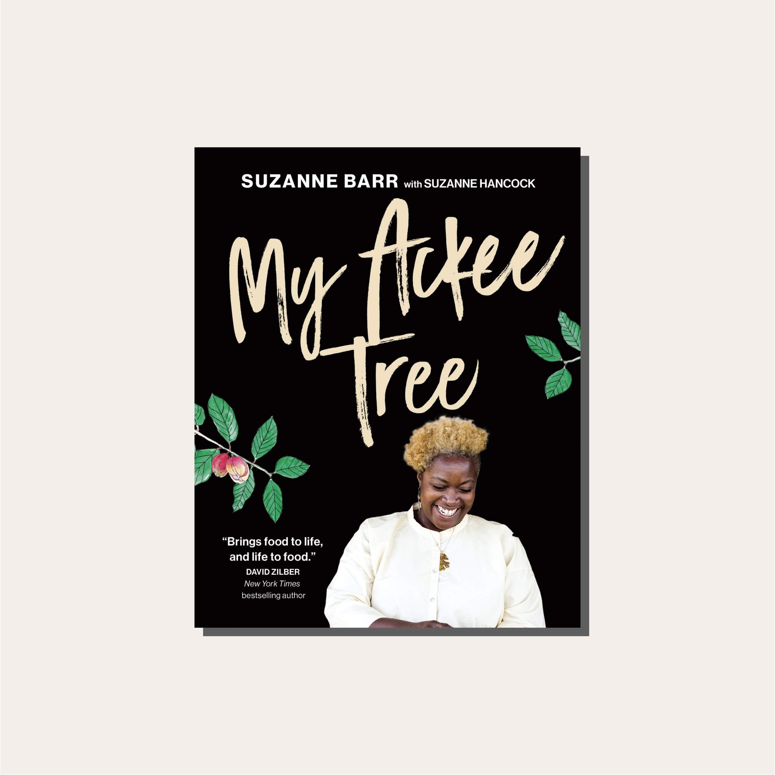 Suzanne Barr's "My Ackee Tree" cookbook cover in a light frame.