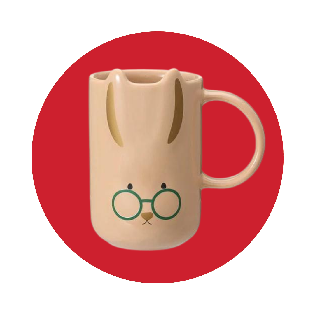 A light tan mug with a bunny face on a red circle.