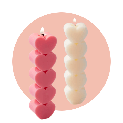 two candles with heart shapes