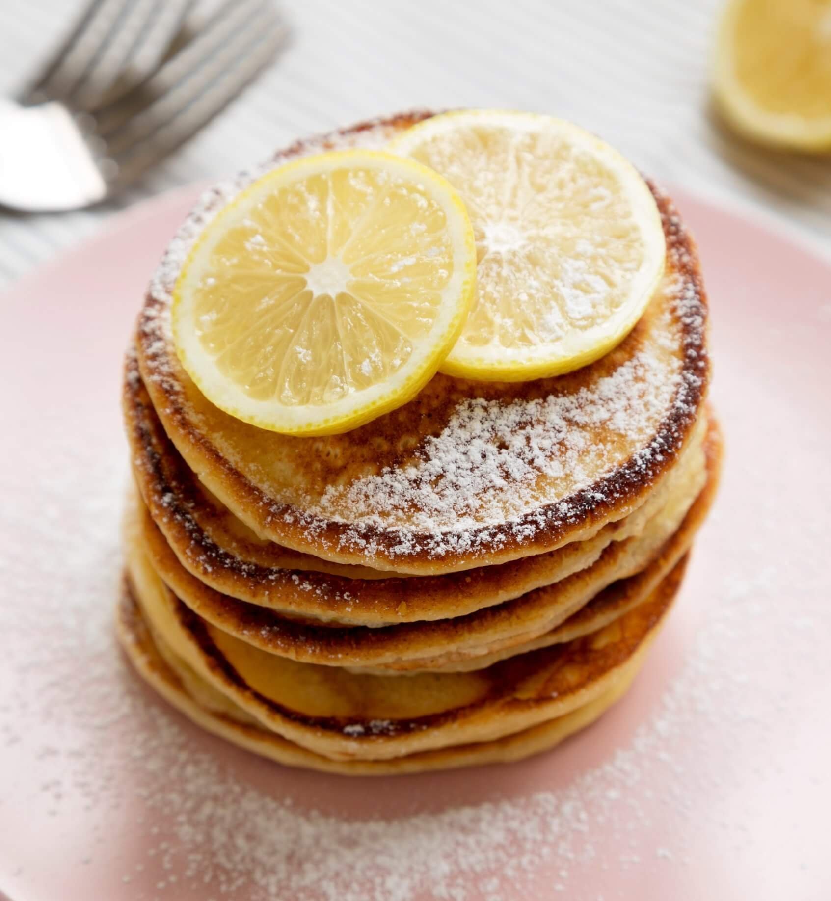 stack of pancakes with lemons on top