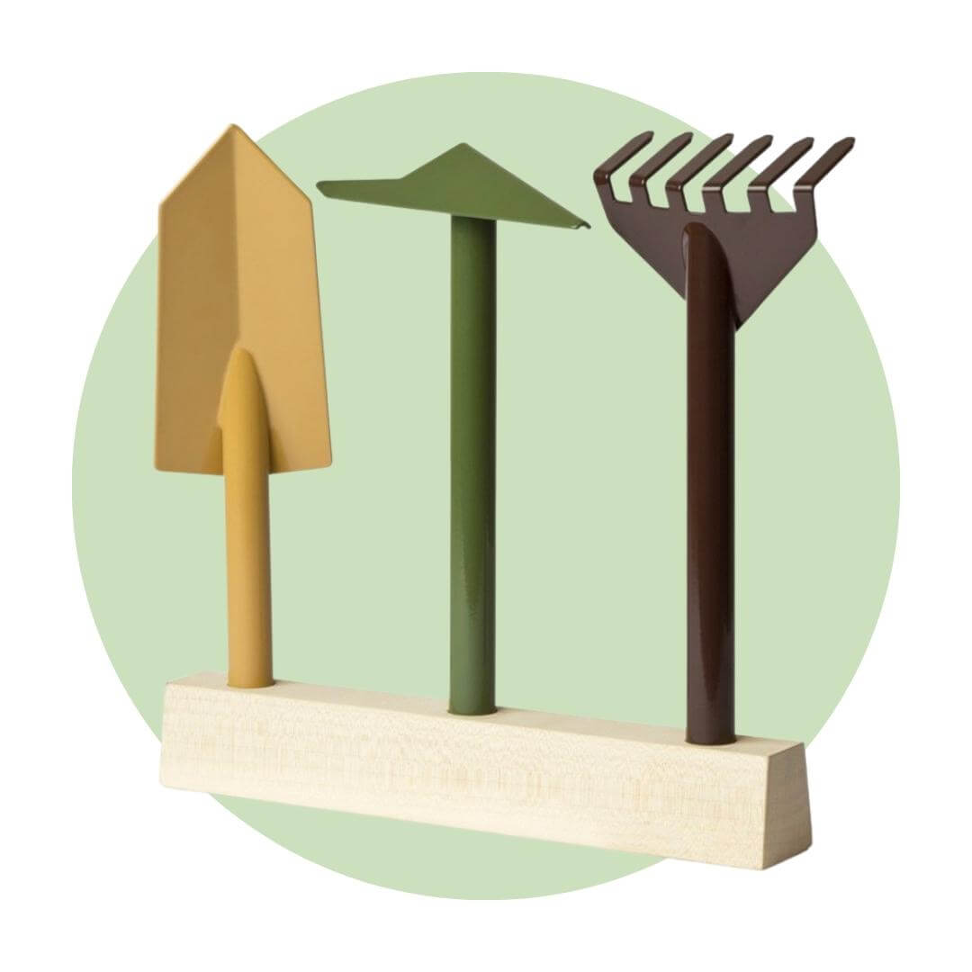 Three handheld gardening tools on a wooden stand over a light green circle