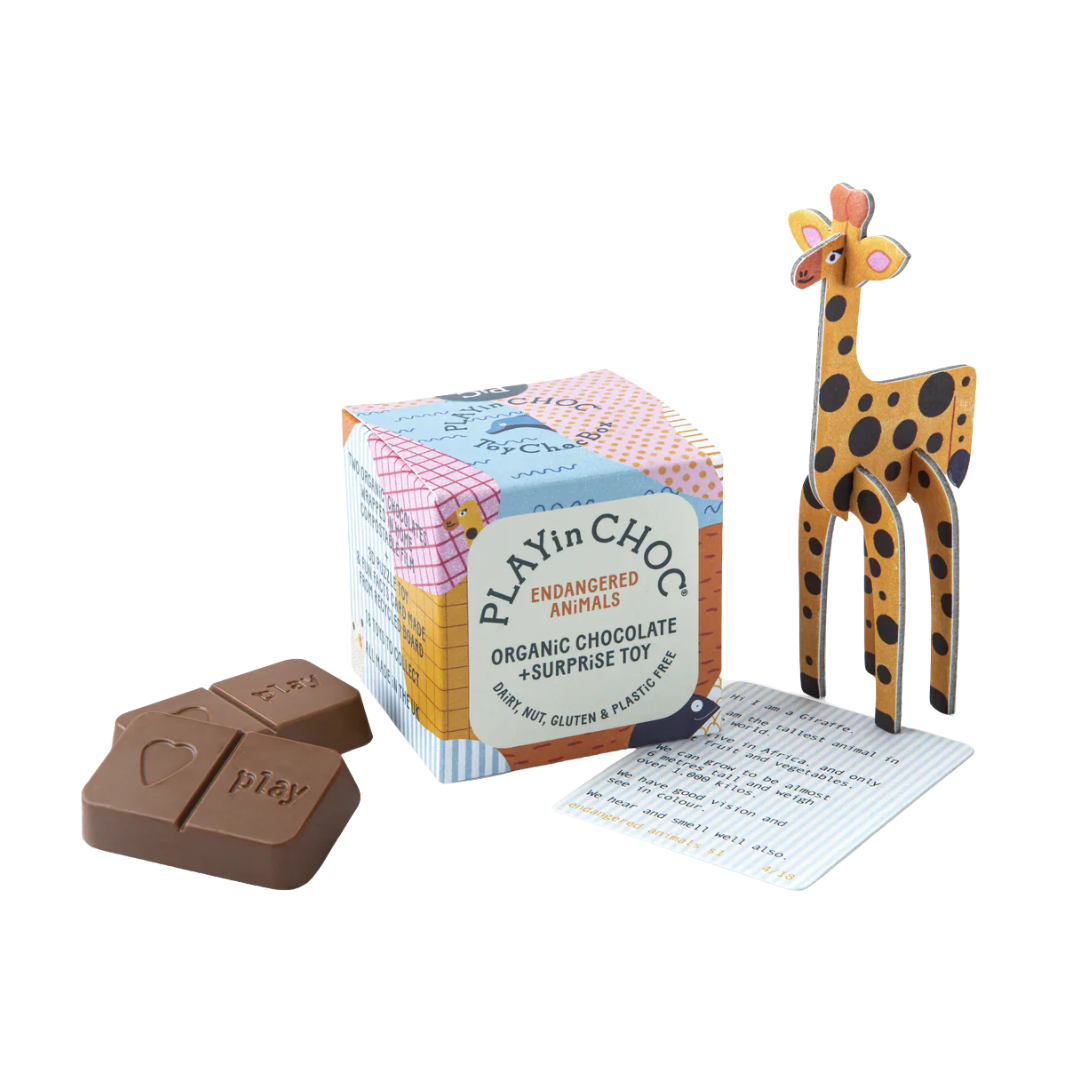 Two tablets of chocolate, a square packaging box and a giraffe toy made from cardboard. 