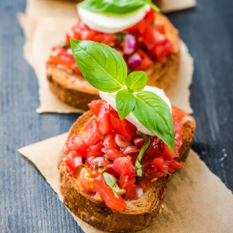 chopped tomatoes on toast with basil