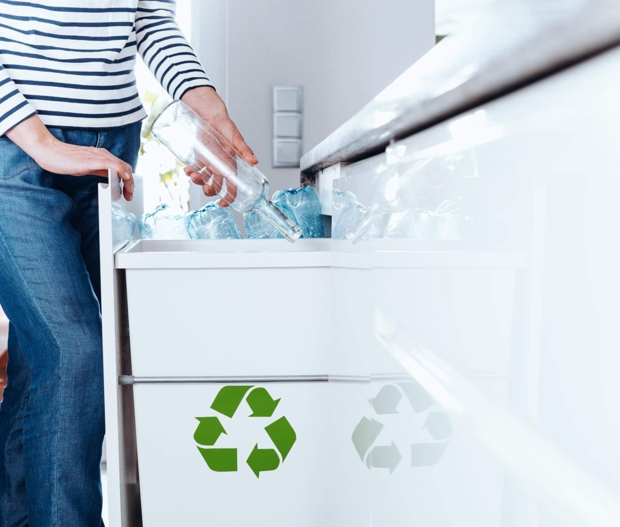 Person sorting glass bottles