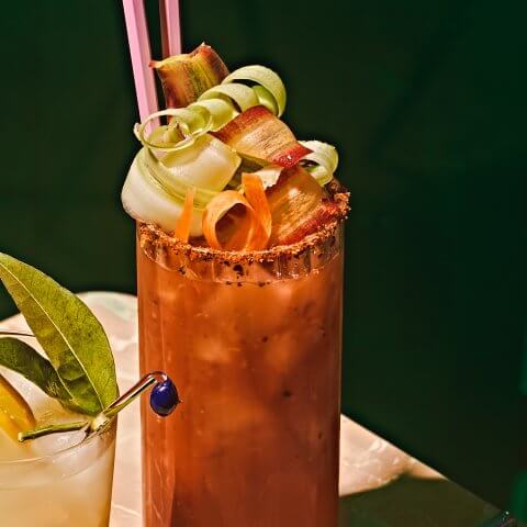 A red caesar on a marble surface with a dark green background.