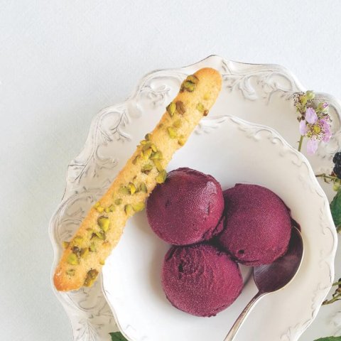 bowl with purple ice cream and long cookie