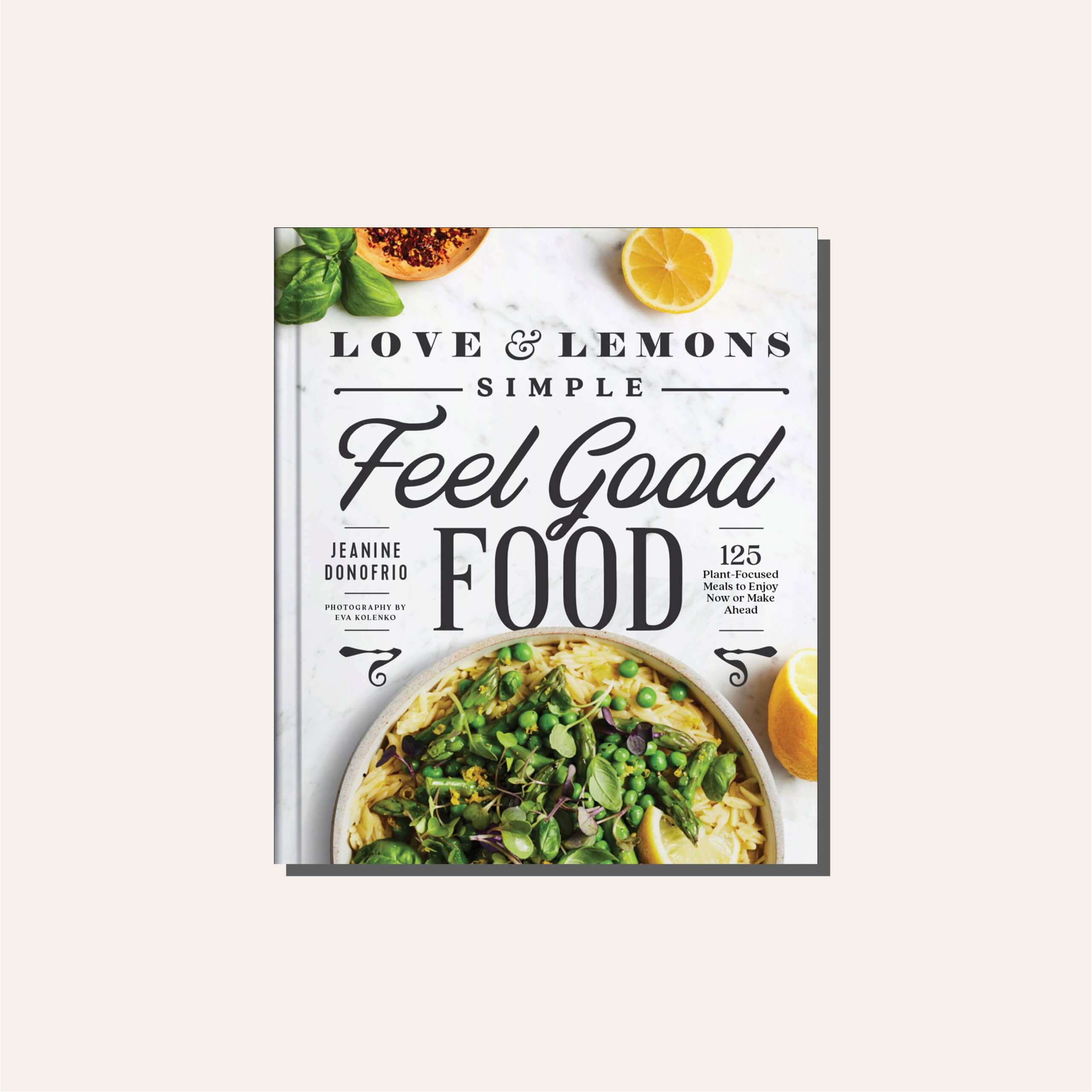 A white and green cookbook cover in a tan frame