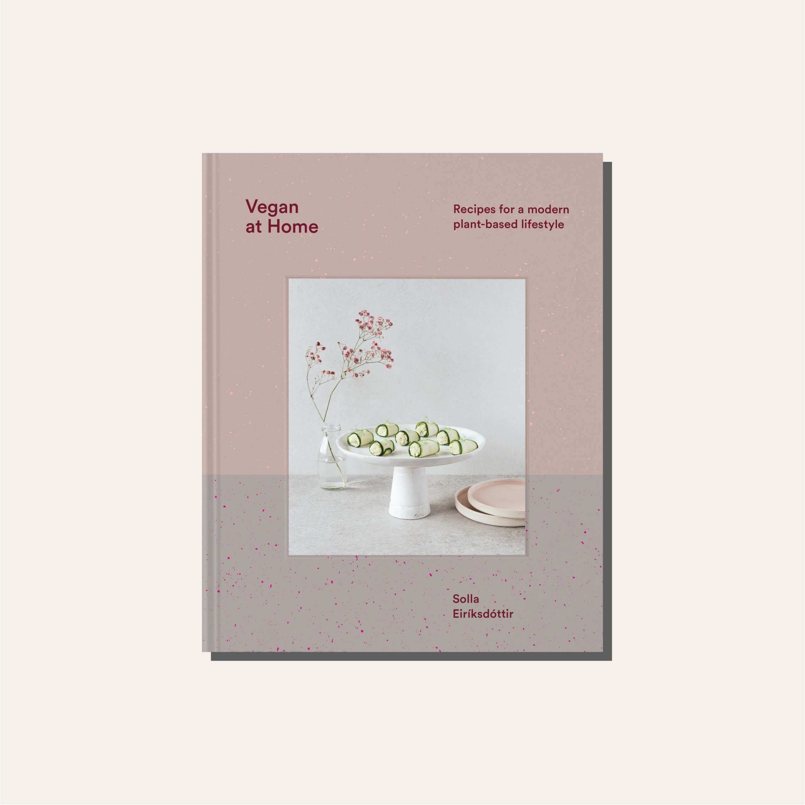 A light pink and grey cookbook cover in a tan frame