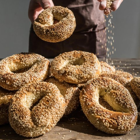 pile of bagels with sesame seeds