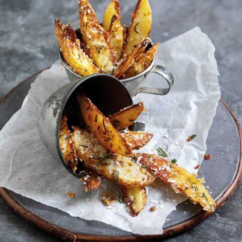 A plate with tin cups of potato wedges dusted in Parmigiano Reggiano cheese