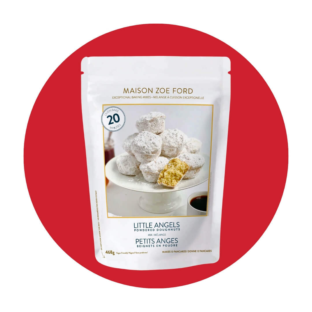 A white bag with a picture of sugared doughnuts on a red circle graphic