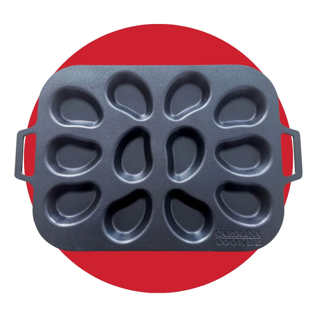 A metal pan with indents for oyster shells on a red circle graphic
