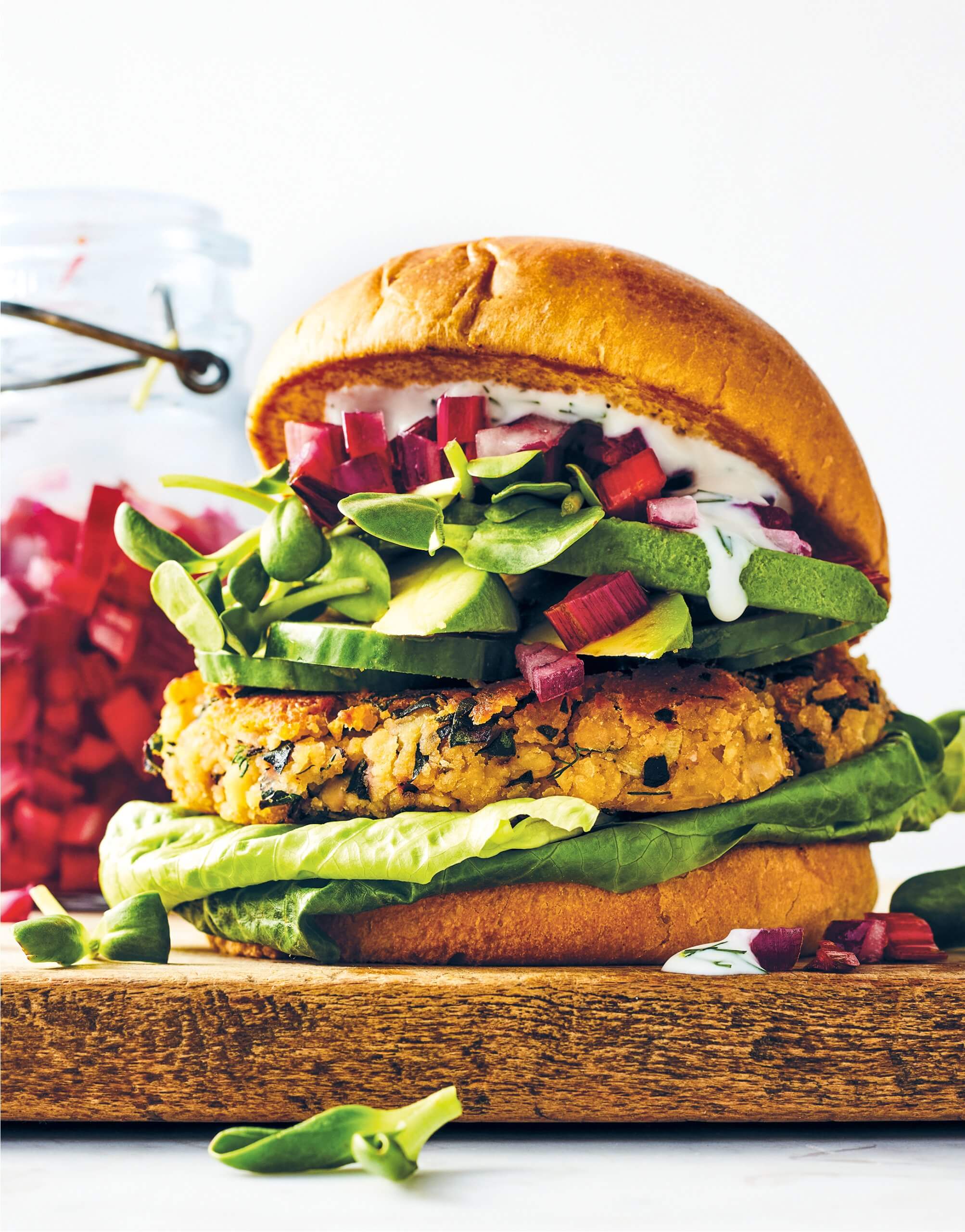 A veggie burger sitting on a wooden block