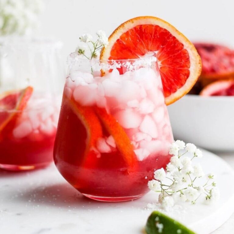 Blood orange margarita garnished with a blood orange wheel.