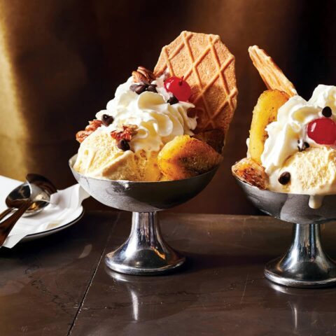 Silver bowls of ice cream with a wafer and sundae decorations