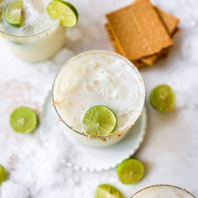 Key lime pie margarita with a graham cracker crumb rim and lime garnish.