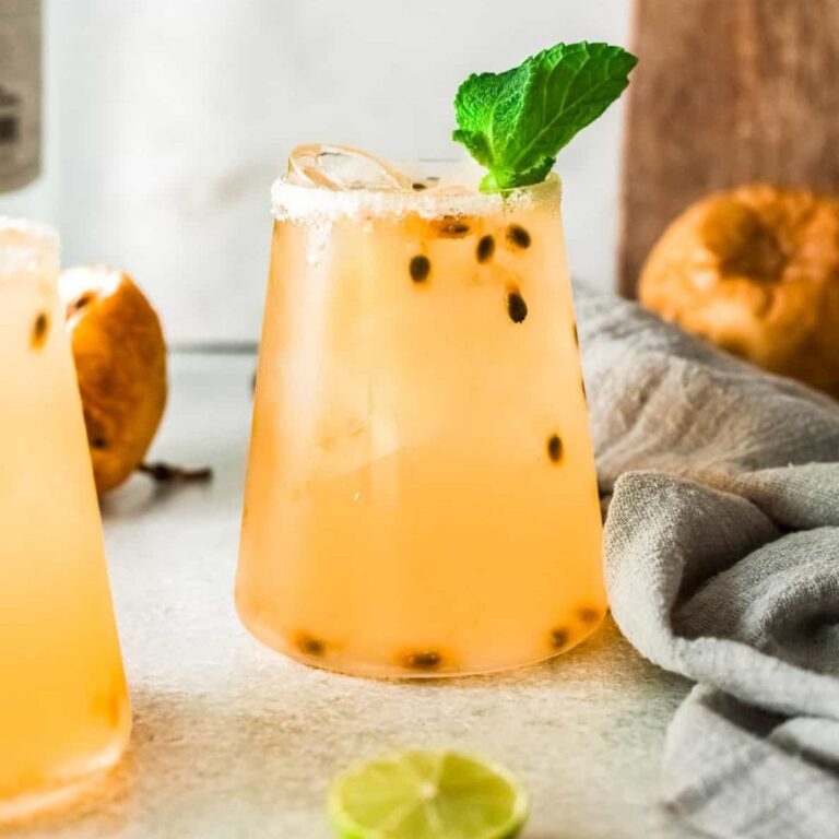 Passionfruit margarita garnished with fresh passionfruit pulp.