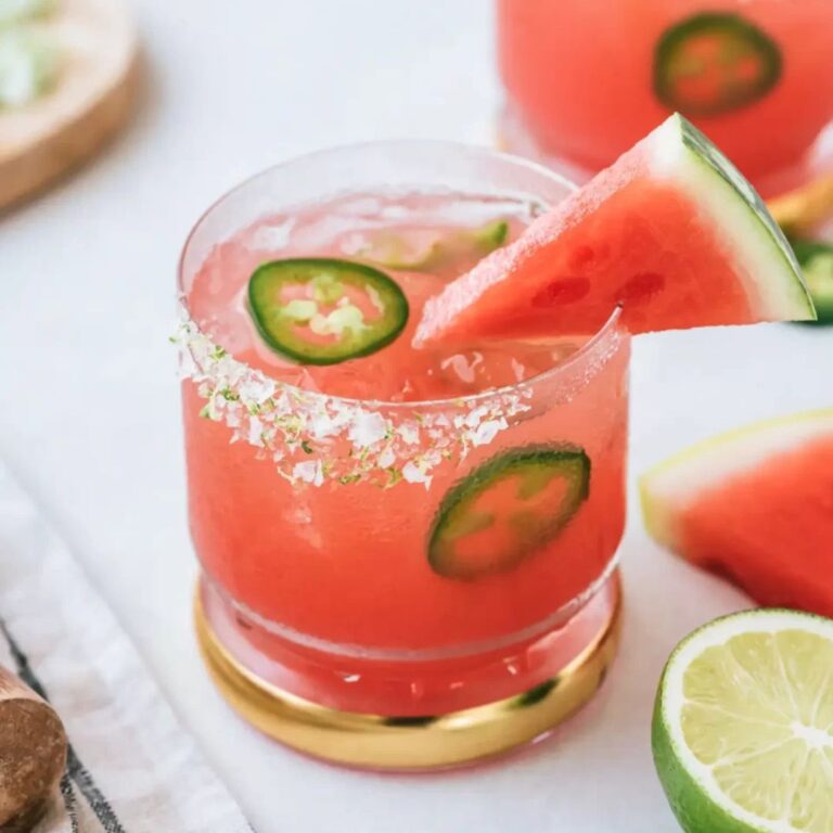Spicy watermelon margarita garnished with watermelon and jalapeño slices.