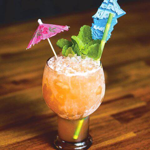 A Tiki rum cocktail on a wooden tabletop