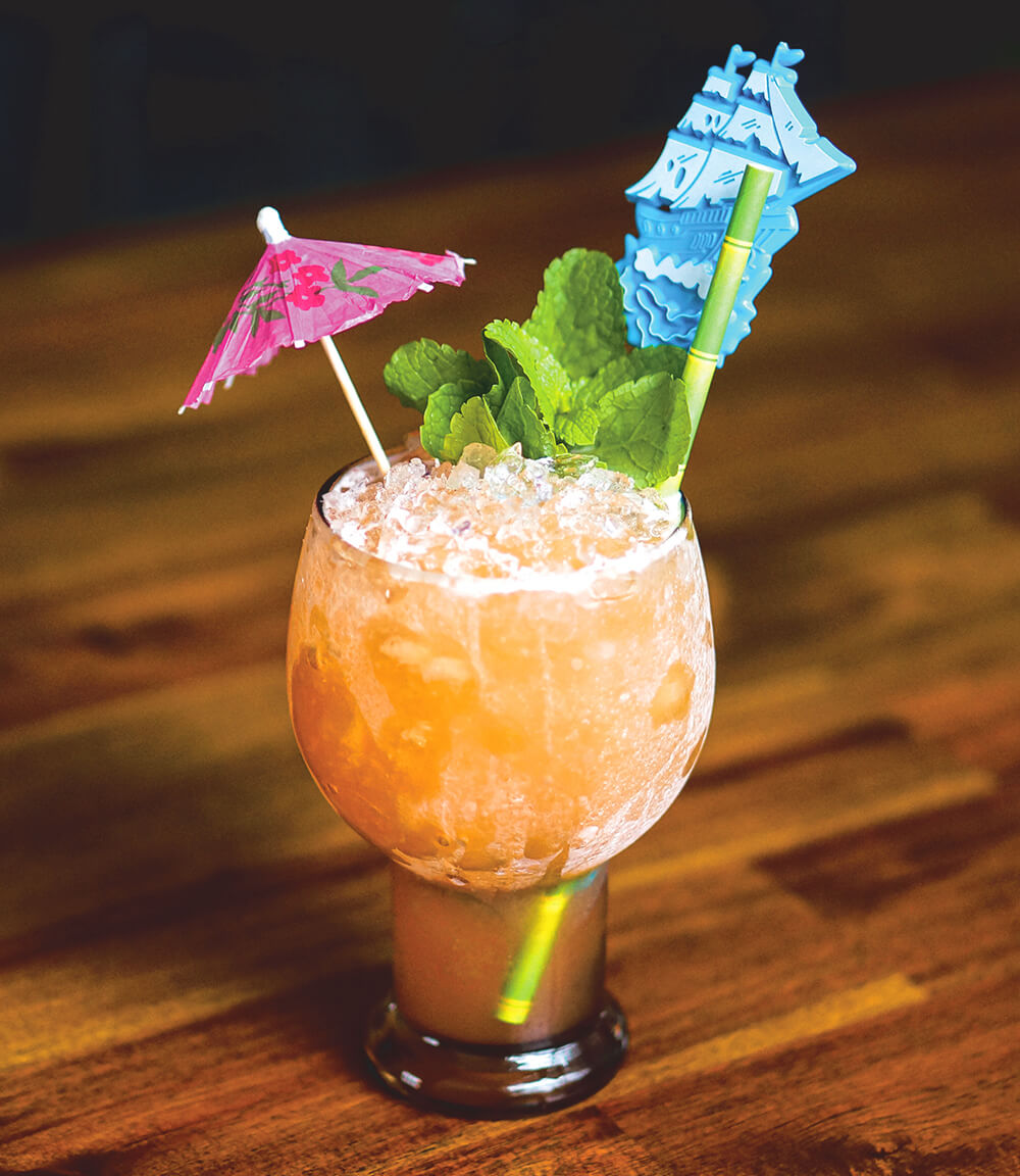 A Tiki rum cocktail on a wooden tabletop